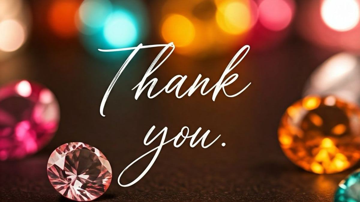 A close-up of a faceted pink gemstone on a dark surface with the words 'Thank you.' in white script over the center.